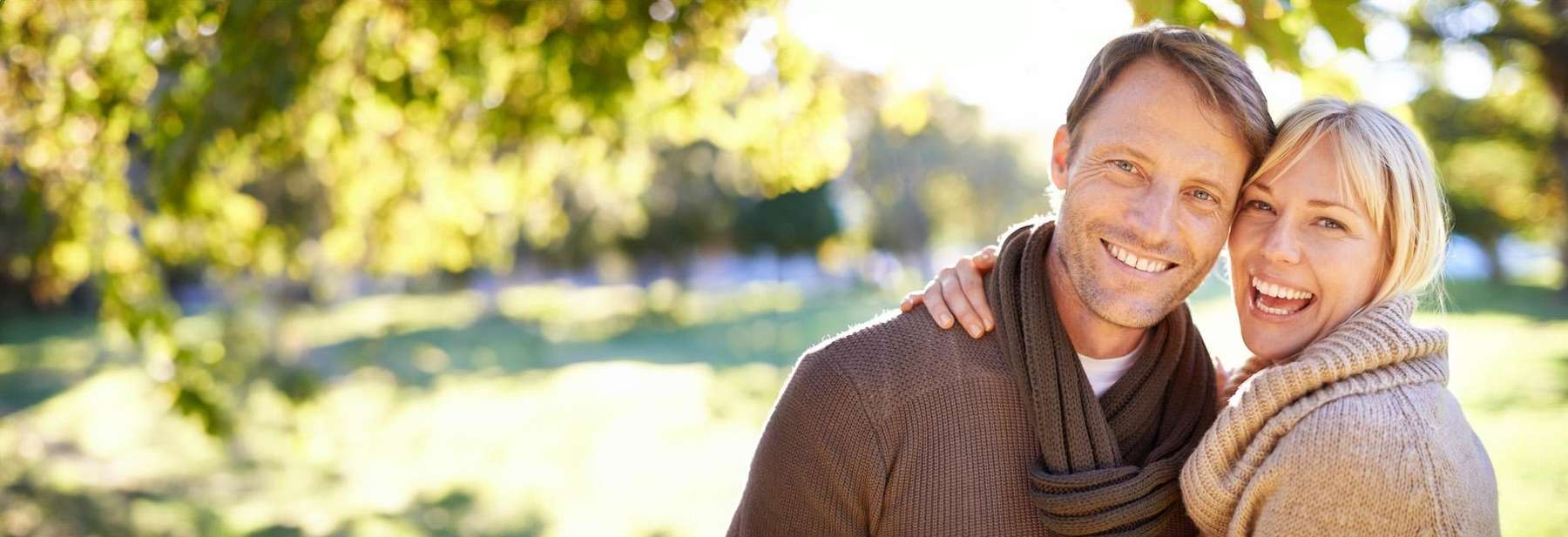 Couple in Chesterfield smiling confidently with their healthy teeth