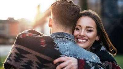 Woman cuddling her partner with a radiant smile in Chesterfield