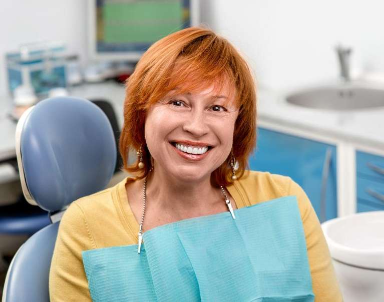 woman comfortably smiling after a teeth cleaning in Chesterfield
