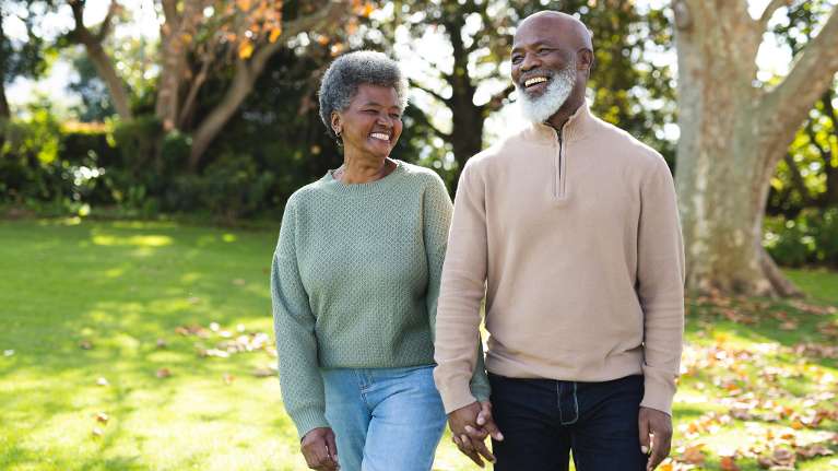 An elderly couple in Chesterfield with a full set of teeth laughing confidently