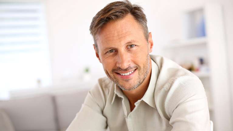 Man in Chesterfield MO smiling with his front dental implant