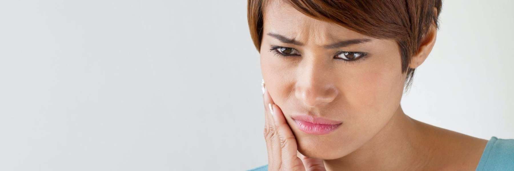 concerned woman touching jaw in Chesterfield MO